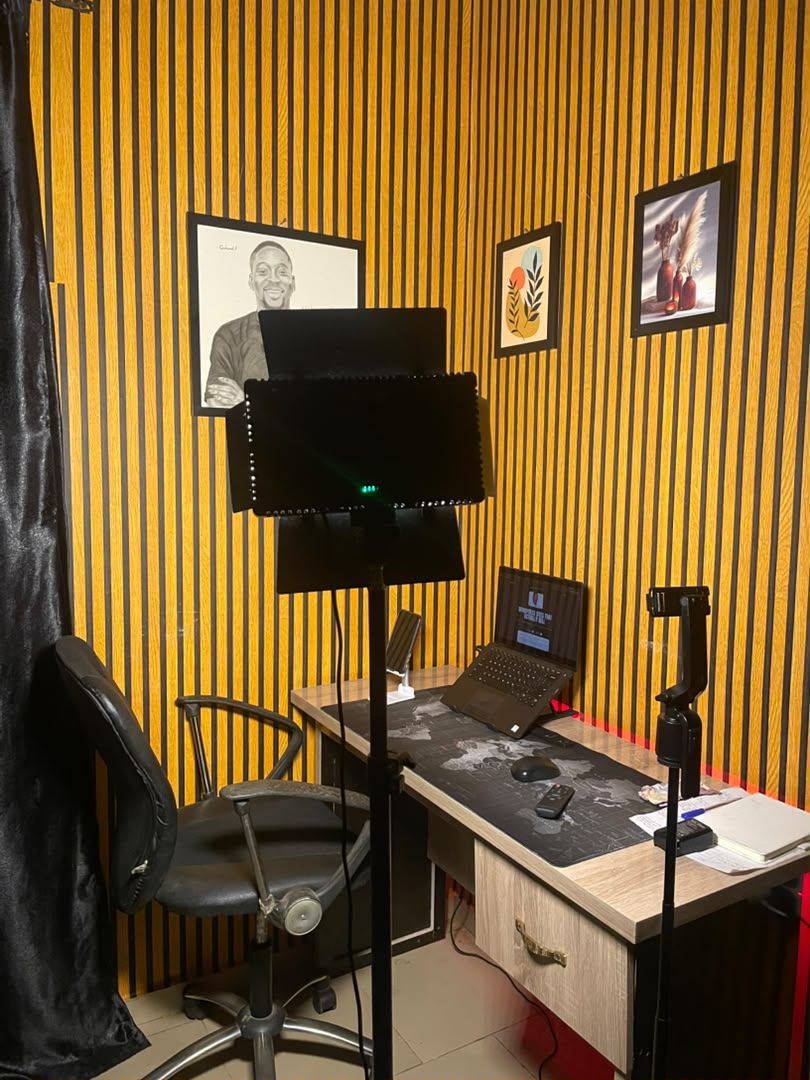 Arms crossed at the studio desk